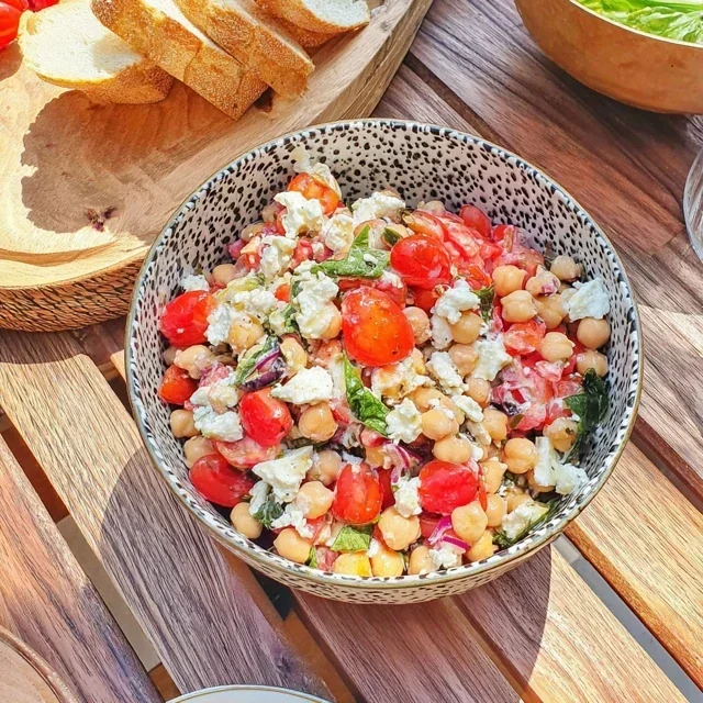 Gezonde salade met geroosterde kikkererwten, verse tomaten en pittige feta